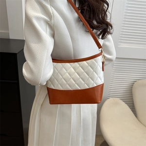 Quilted white and brown PU leather crossbody bag shown on a model's shoulder