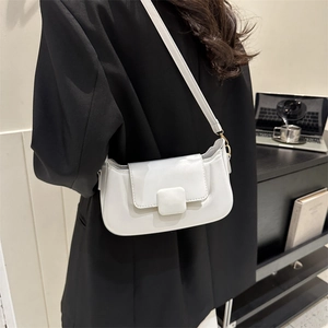 Detailed view of a white minimalist PU shoulder bag worn by a model in office setting