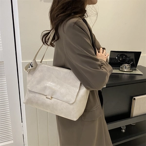 Chic light beige PU leather messenger bag featuring a stylish wide strap with M lettering