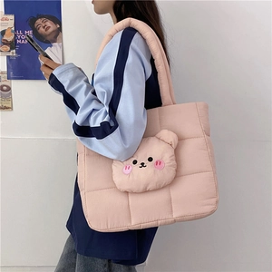 Pink quilted nylon tote bag with a 3D plush teddy bear mascot and padded shoulder strap