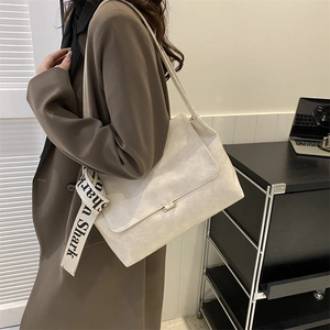 Detail of off-white PU leather shoulder bag featuring a Shark lettered decorative strap