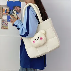 Detail of off-white quilted nylon tote bag with cute plush 3D bear head accessory