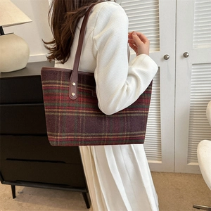 Retro plaid tote bag with brown leather straps shown in a cozy home setting