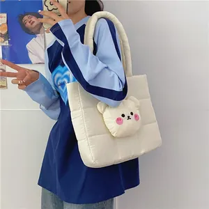 Close-up of quilted nylon shoulder bag with cute 3D plush bear detail and padded handle