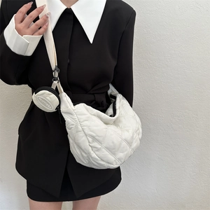 Detail of white quilted crossbody bag with a round coin purse and FANYISSA logo detail