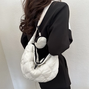 Quilted white crescent moon crossbody bag with matching round coin purse detail