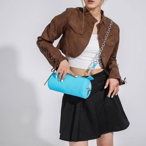 Detail of bright blue cylindrical PU leather bag with silver star and chunky chain strap