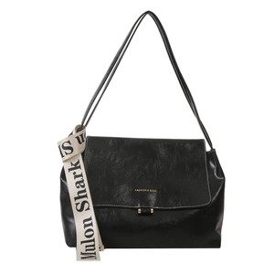 Minimalist black PU leather crossbody bag with a trendy white branded woven strap detail
