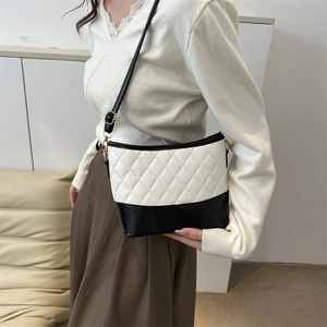 Detail of classic black and white contrast leather crossbody bag with quilted pattern