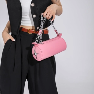 Pink cylindrical handbag with chunky silver chain and star metal detail in Y2K style