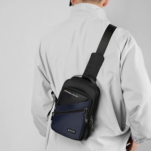 Detailed view of fashion nylon chest bag with layered zippers and branded text logo