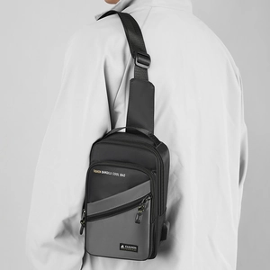 Close-up of black and grey nylon chest bag with fashion logo and adjustable strap