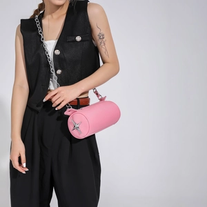 Pink cylinder crossbody bag featuring silver star metal detail and stylish chain strap
