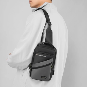 Detail view of nylon chest bag with adjustable shoulder strap and multi-zipper pockets