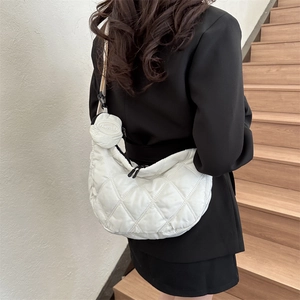 White quilted half-moon crossbody bag in waterproof nylon with small round pouch
