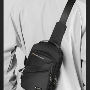 Waterproof black nylon sling bag with padded shoulder strap and front zip pocket