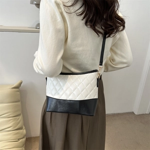 French style minimalist quilted crossbody bag in black and white leather on female model