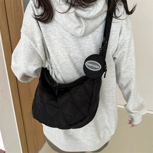 Quilted black crescent crossbody bag with adjustable wide strap and round coin purse