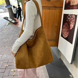 Detailed view of large brown suede tote bag made with premium soft woolen fabric