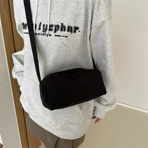 Minimalist black rectangular crossbody bag with wide shoulder strap in premium nylon