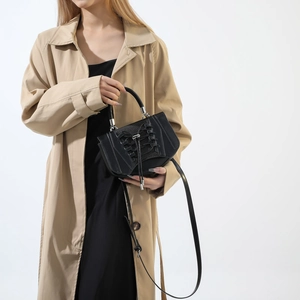 Detail view of black PU leather handbag featuring unique corset-style lace-up design element