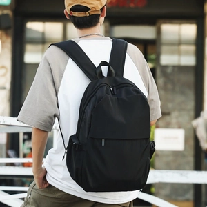 Minimalist black nylon backpack for women with dual zippers and padded shoulder straps
