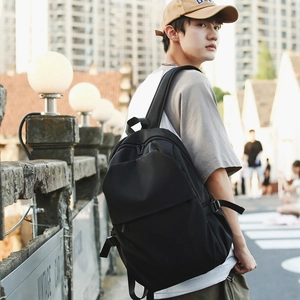 Chic black nylon backpack for women with minimalist design in a city street scene