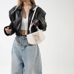 White minimalist handbag featuring corset-style lace-up design and mesh paneling