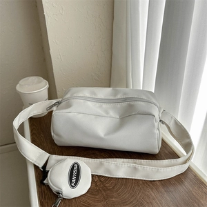 Detail of white nylon crossbody bag with a round branded coin purse on strap