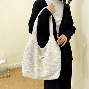 Detail of colorful knit tote bag featuring a striped pattern and minimalist fabric label