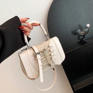 Close-up of white crossbody bag with corset-style lace-up detailing and mesh fabric
