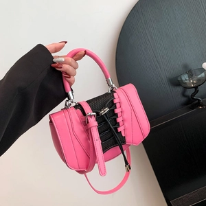 Detail of a bright pink PU leather mini bag with black lace-up design and silver hardware