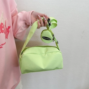 Neon green nylon shoulder bag with small round coin purse and wide crossbody strap