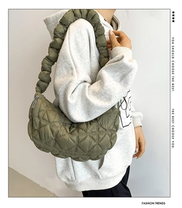 Detail of army green quilted crescent bag with scrunchie handle and rhombus pattern