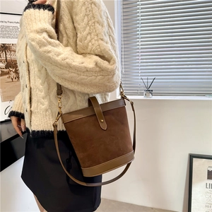 Chocolate brown suede bucket bag for women with vintage metal buckle and crossbody strap