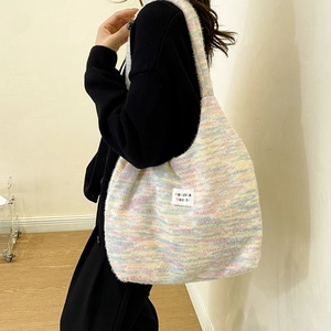 Close-up of the rainbow knitted mohair texture and brand label on a stylish tote bag