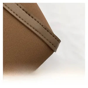 Close-up of brown matte faux leather bag with high-quality double-line stitching detail
