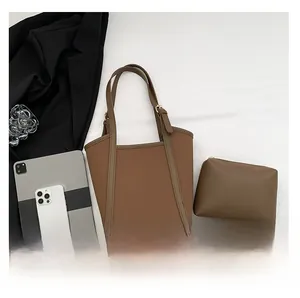 Detail view of brown PU leather tote bag set including a small zipper pouch and long strap