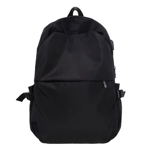 Minimalist black nylon backpack with USB port and top handle for modern women