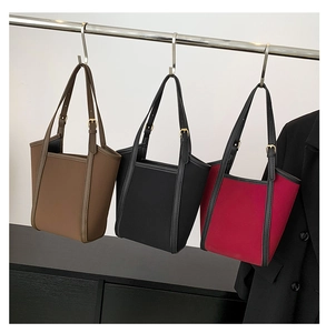 Detailed view of luxury PU leather tote bags in dark brown, black, and vibrant magenta colors