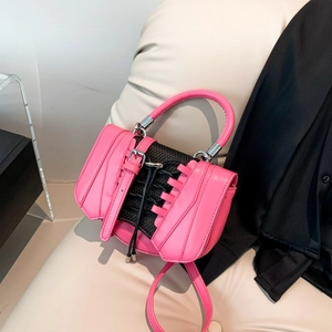 Detail of creative sneaker-style handbag with black mesh texture and lacing in pink