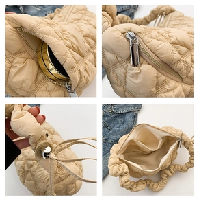 Detail view of beige quilted bubble handbag with silver zipper and spacious inner pocket