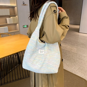 Close-up of high-end knit tote bag with colorful mosaic pattern and soft suede texture