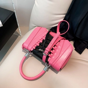 Detail of pink PU leather handbag featuring sneaker-style laces and black mesh inserts