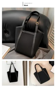 Detail view of a black structured PU leather tote bag with long straps and minimalist design