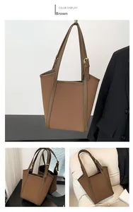 Detail view of brown tote bag with adjustable shoulder strap and gold hardware accents