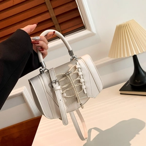 Detail of minimalist beige PU leather handbag with mesh fabric and drawstring design