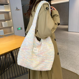 Detailed knit texture of macaron rainbow tote bag with woven brand label on side