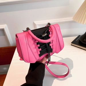 Close-up of creative pink and black crossbody bag featuring unique sneaker-style laces