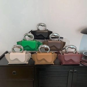 Detailed view of 6 colorful trapezoid handbags with silver wavy handles and matte finish